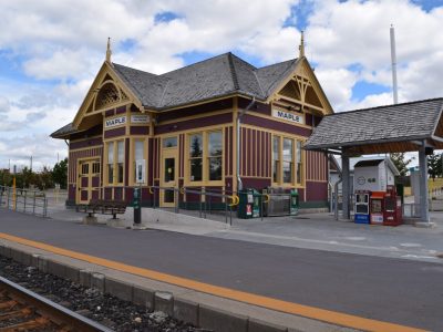 Heritage-style Maple GO train station with yellow trim and red siding